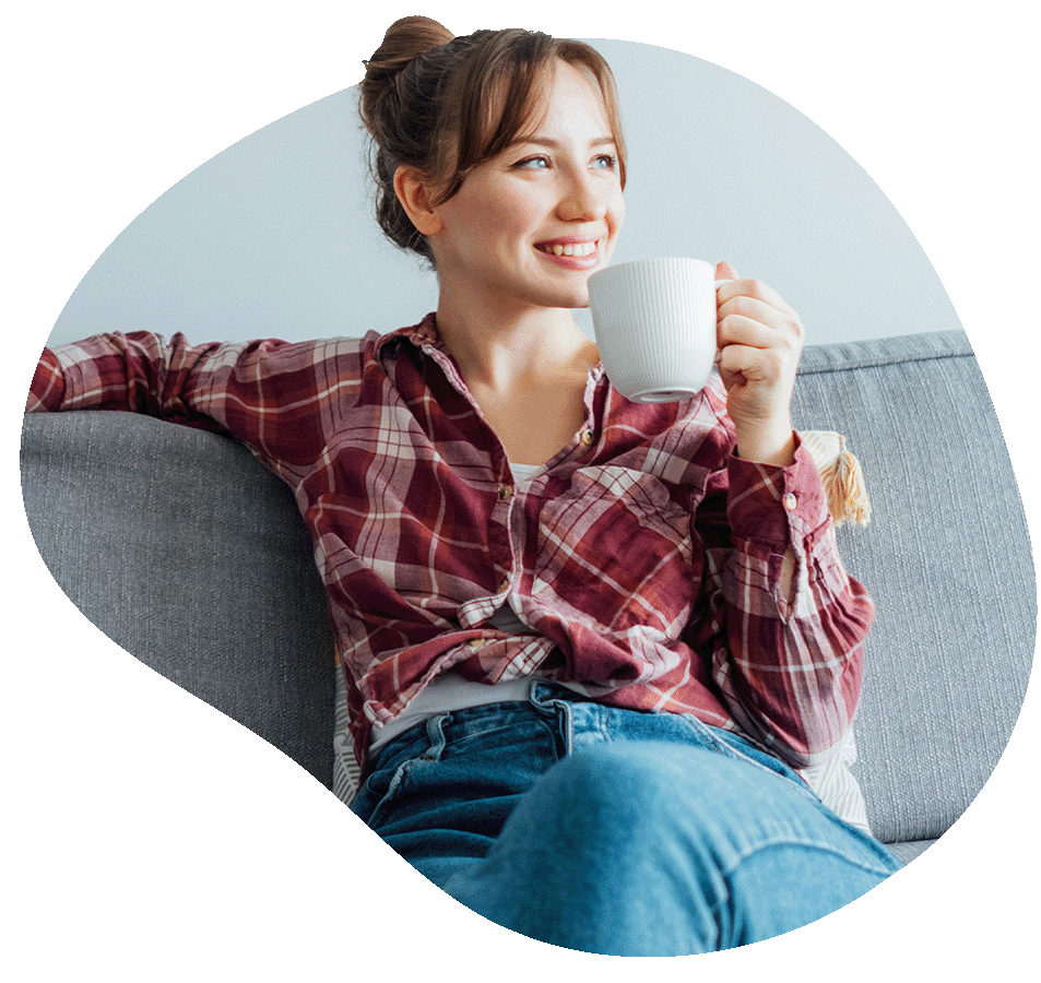 Woman relaxing on couch with mug