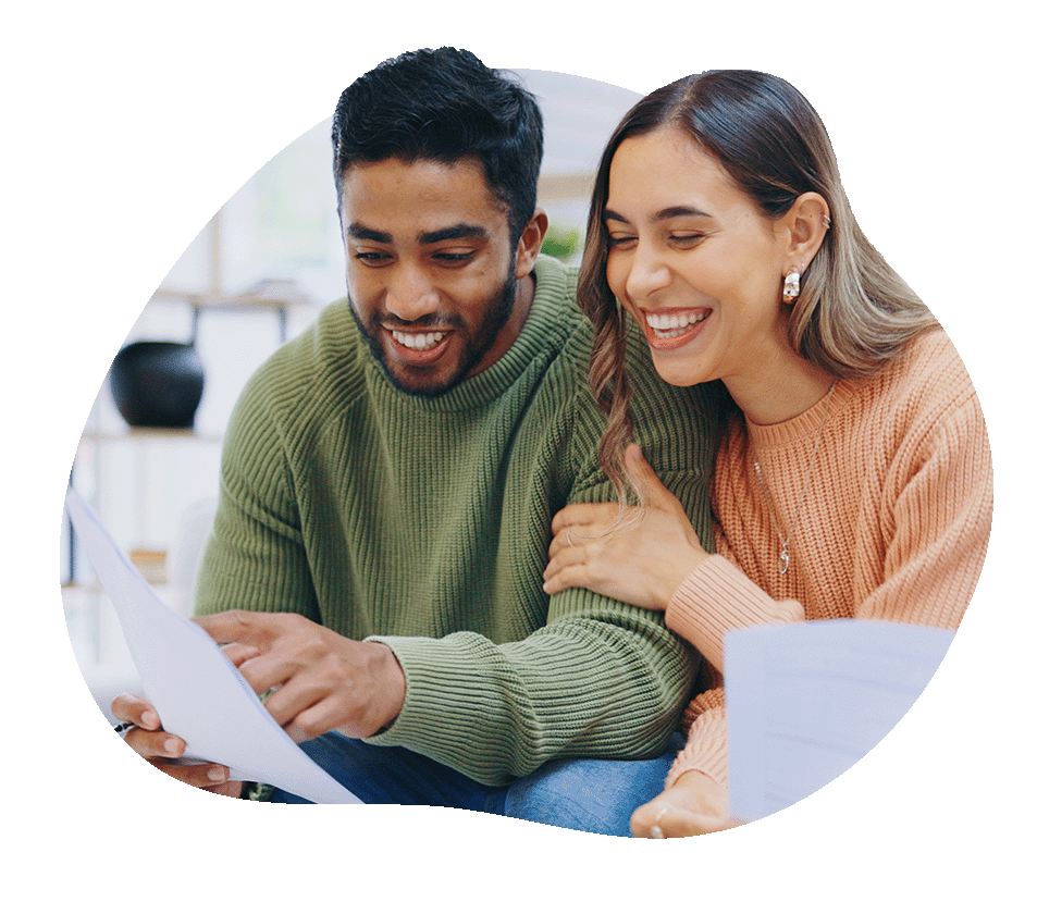 Couple smiling looking at a paper