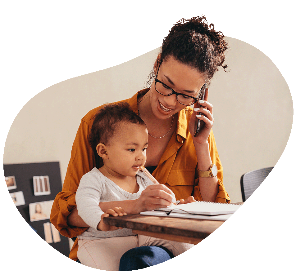 Woman holding baby while on the phone
