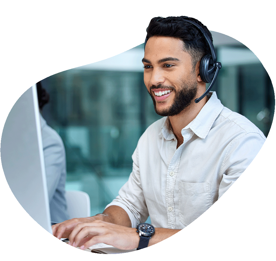 Man on computer with headset on