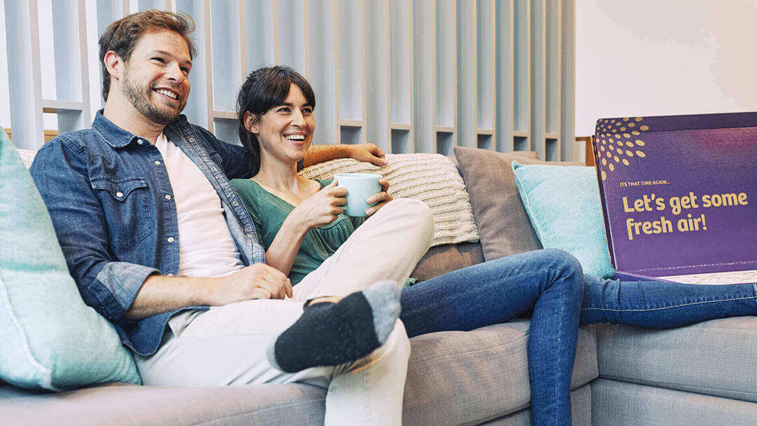 couple on couch with Second Nature box nearby